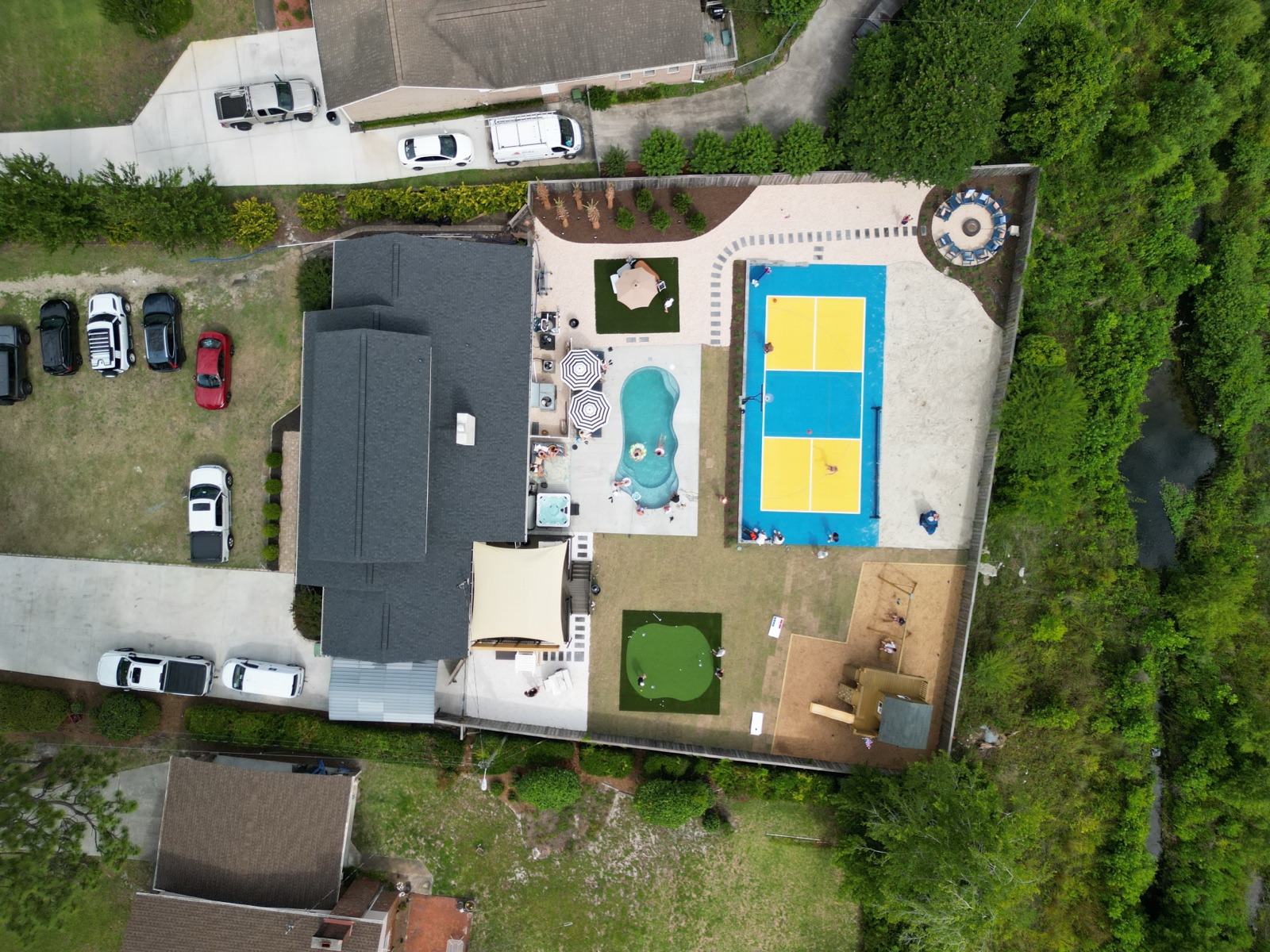 Golden Dune Getaway aerial view after the renovation: pool, pickleball court, putting green, and playground