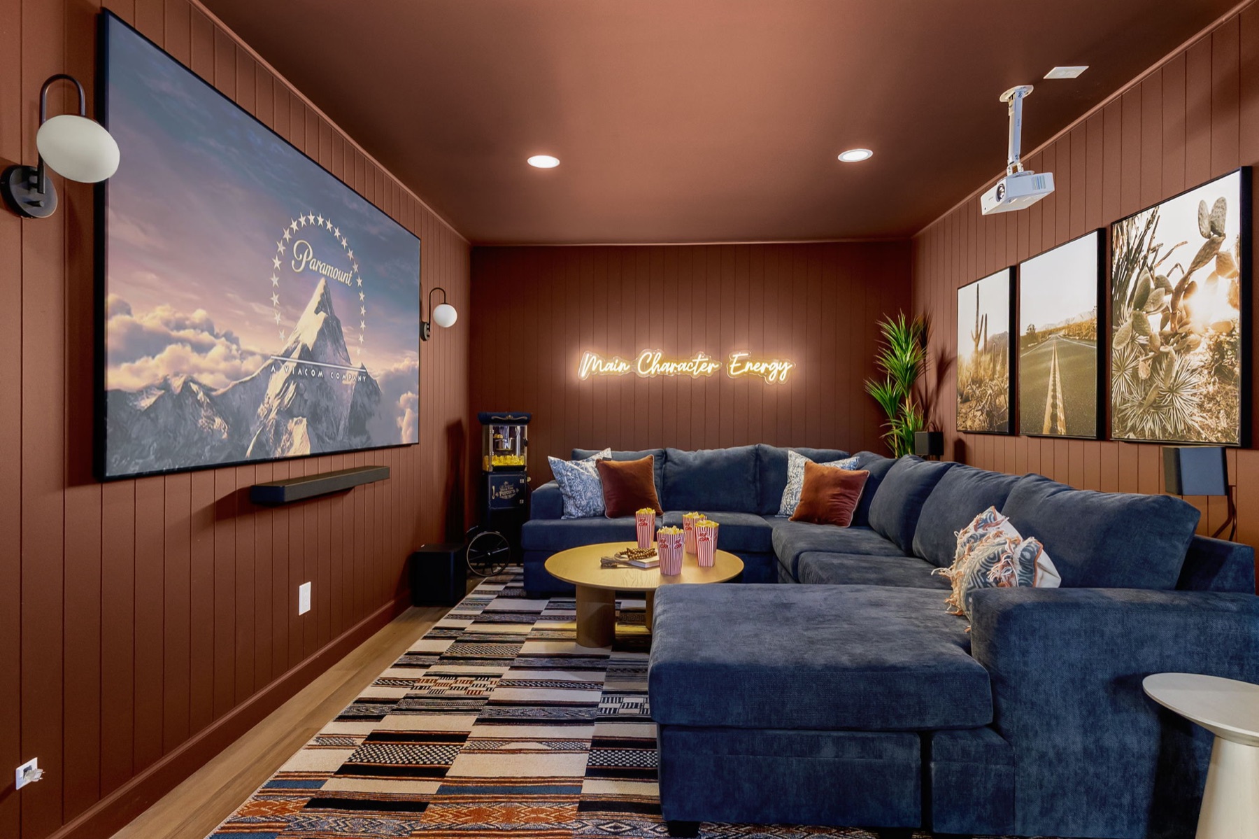 Sunset Social private movie theater with projector screen and sectional seating